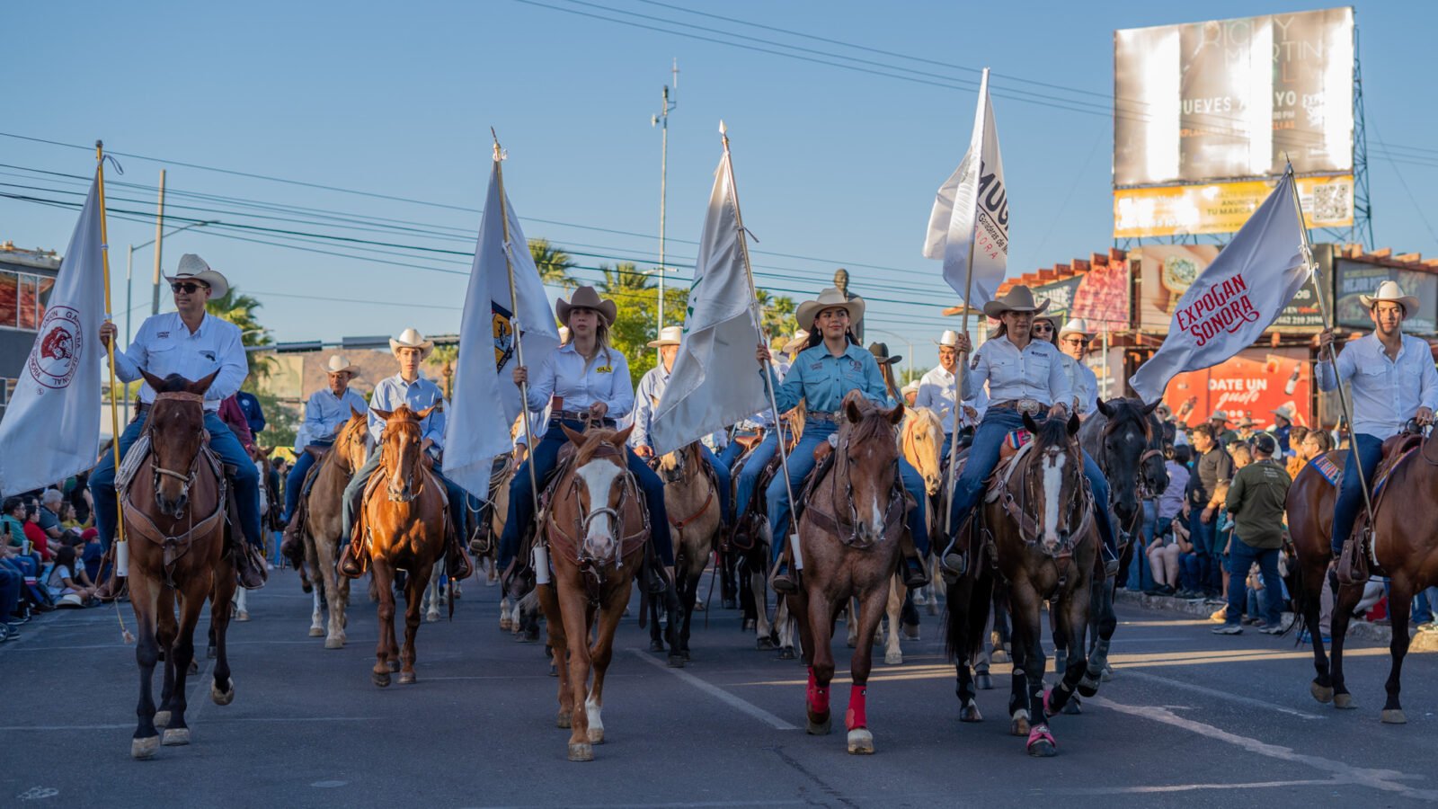 Jinetes y carros alegóricos desfilando en la Manifestación de la ExpoGan Sonora en Hermosillo.