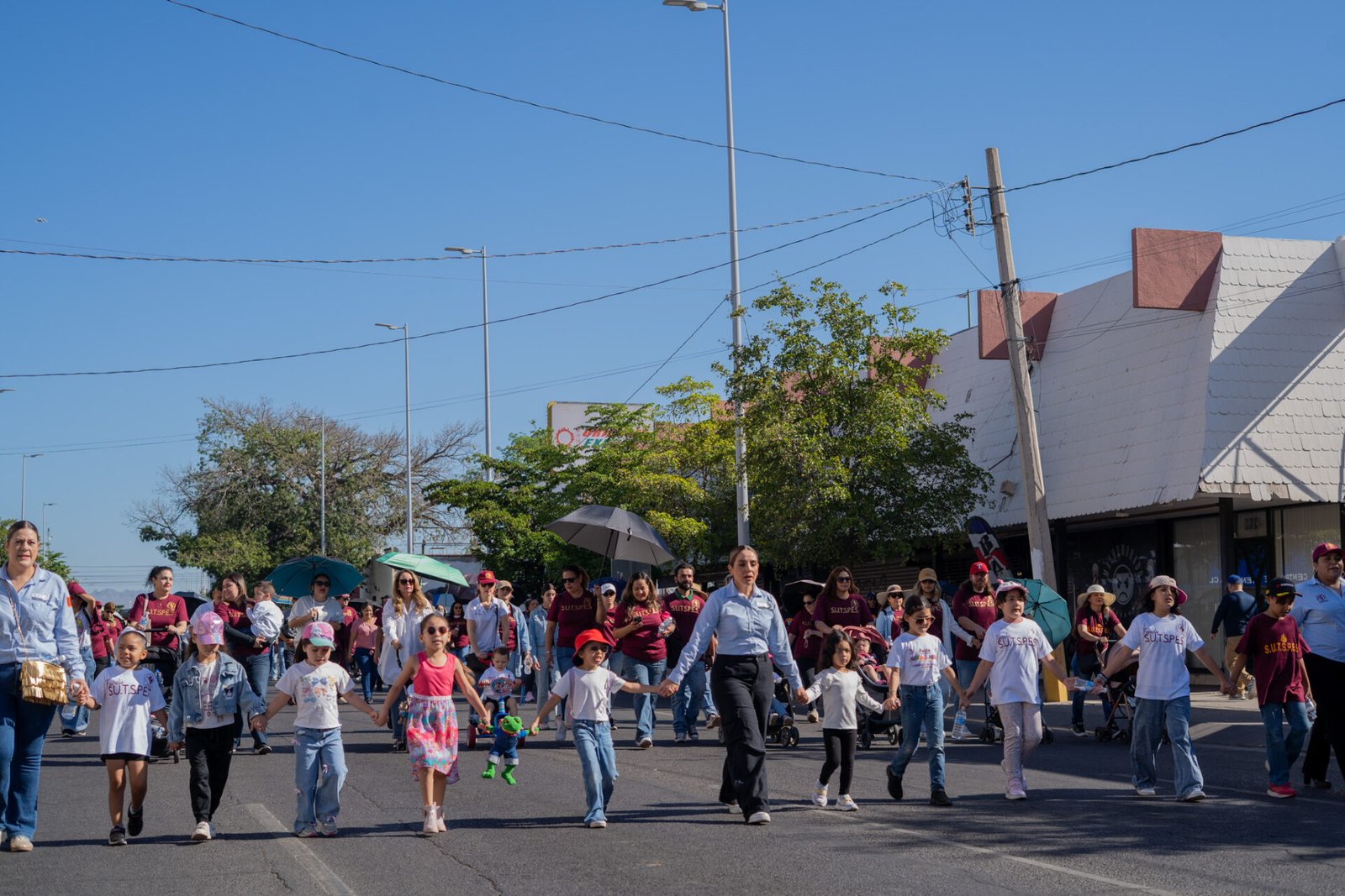 Contingente sosteniendo la lona principal con las 8 demandas laborales durante el desfile del Día del Trabajo en Hermosillo.
